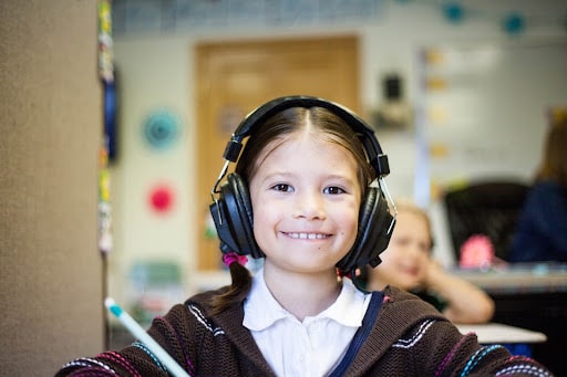 Student with headphone smiling